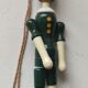 Green pinochio puppet in old wood