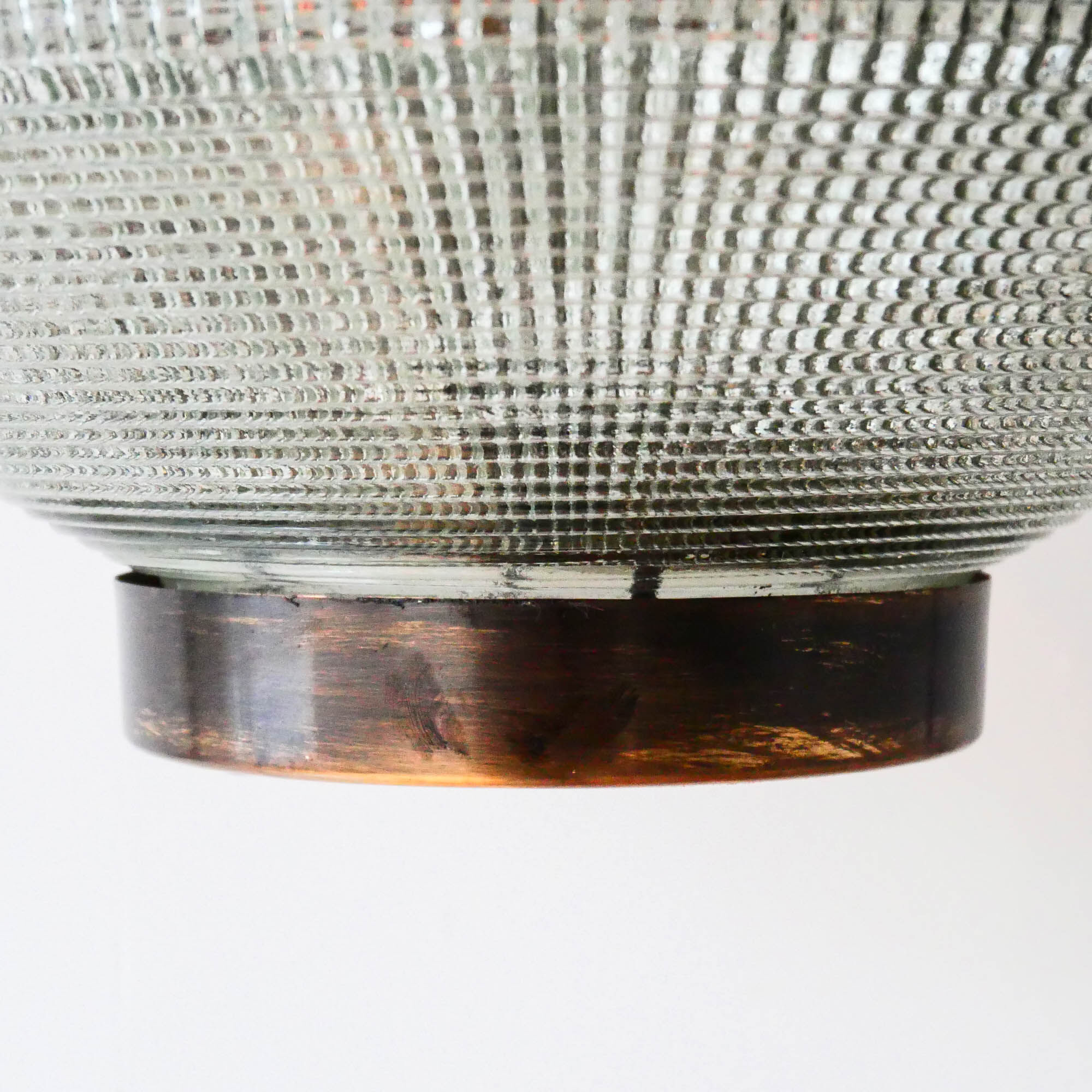 “Ellipse” pendant light in glass and patinated brass.