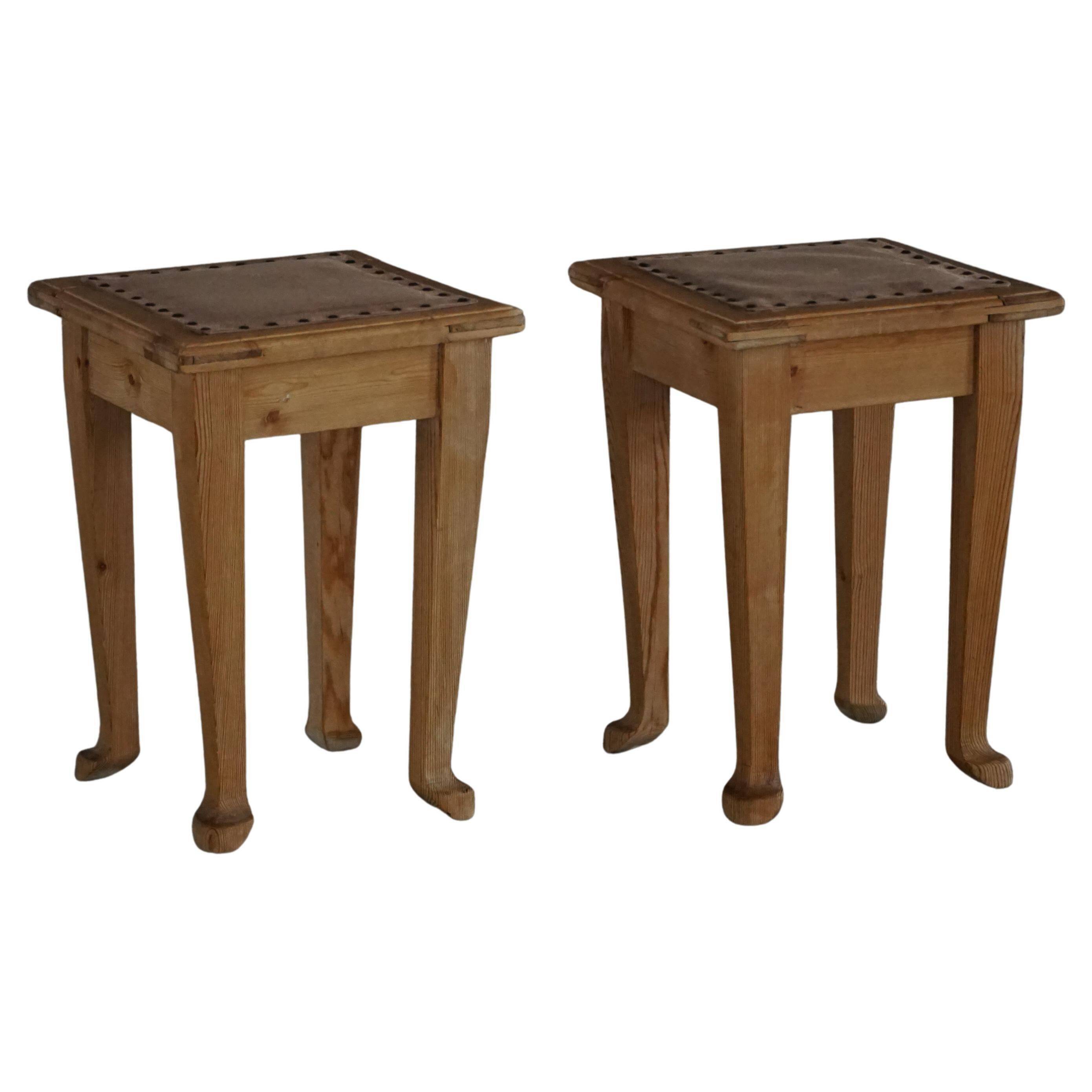 A pair of antique Danish pine stools from the late 19th century.