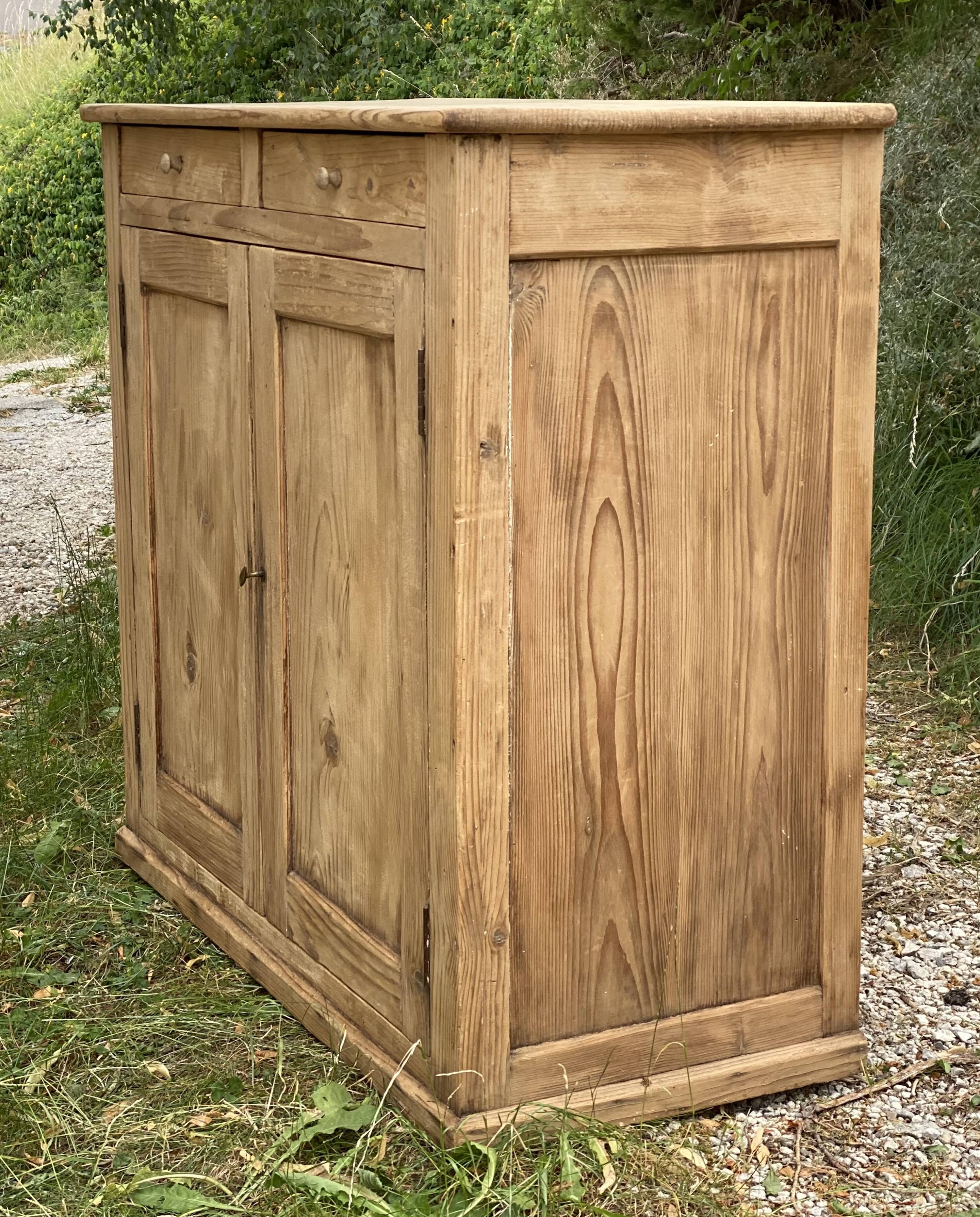 Small Parisian buffet with 2 doors and 2 drawers in light wood.