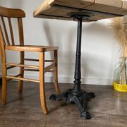 Bistro table with a central cast iron base in industrial style.
