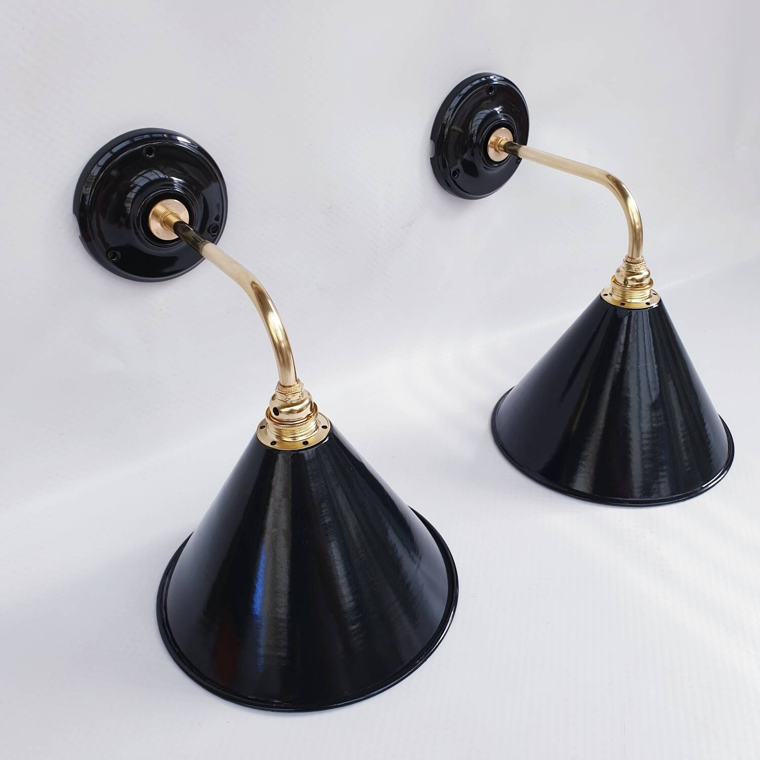 Pair of antique black enamelled sheet metal wall lights