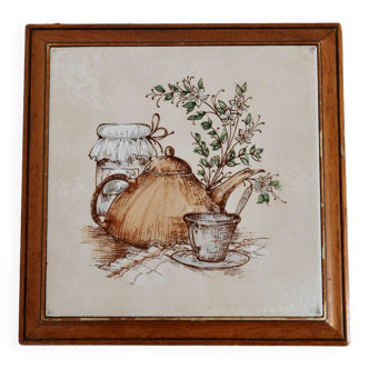 Vintage wooden trivet on foot and earthenware tile