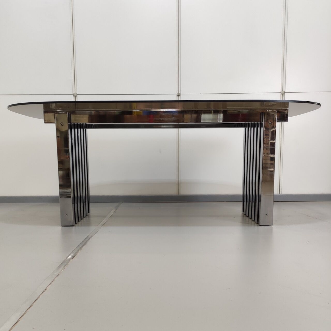 Chrome base diningroom table with smoked glass oval top