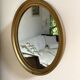 Oval mirror in gilded wood
