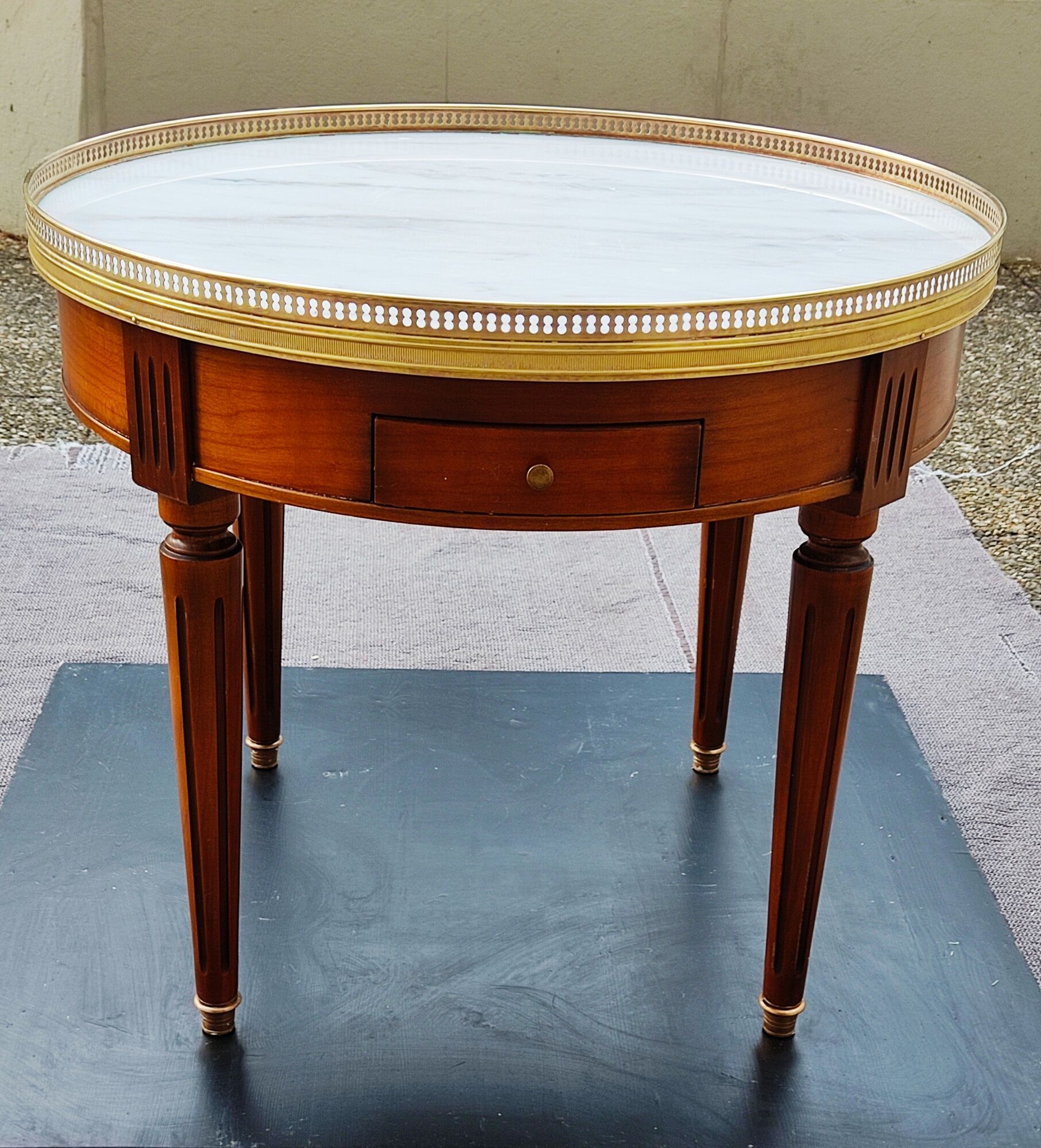 French hot water bottle table in Louis XVI style (1890); marble top and bronze gallery