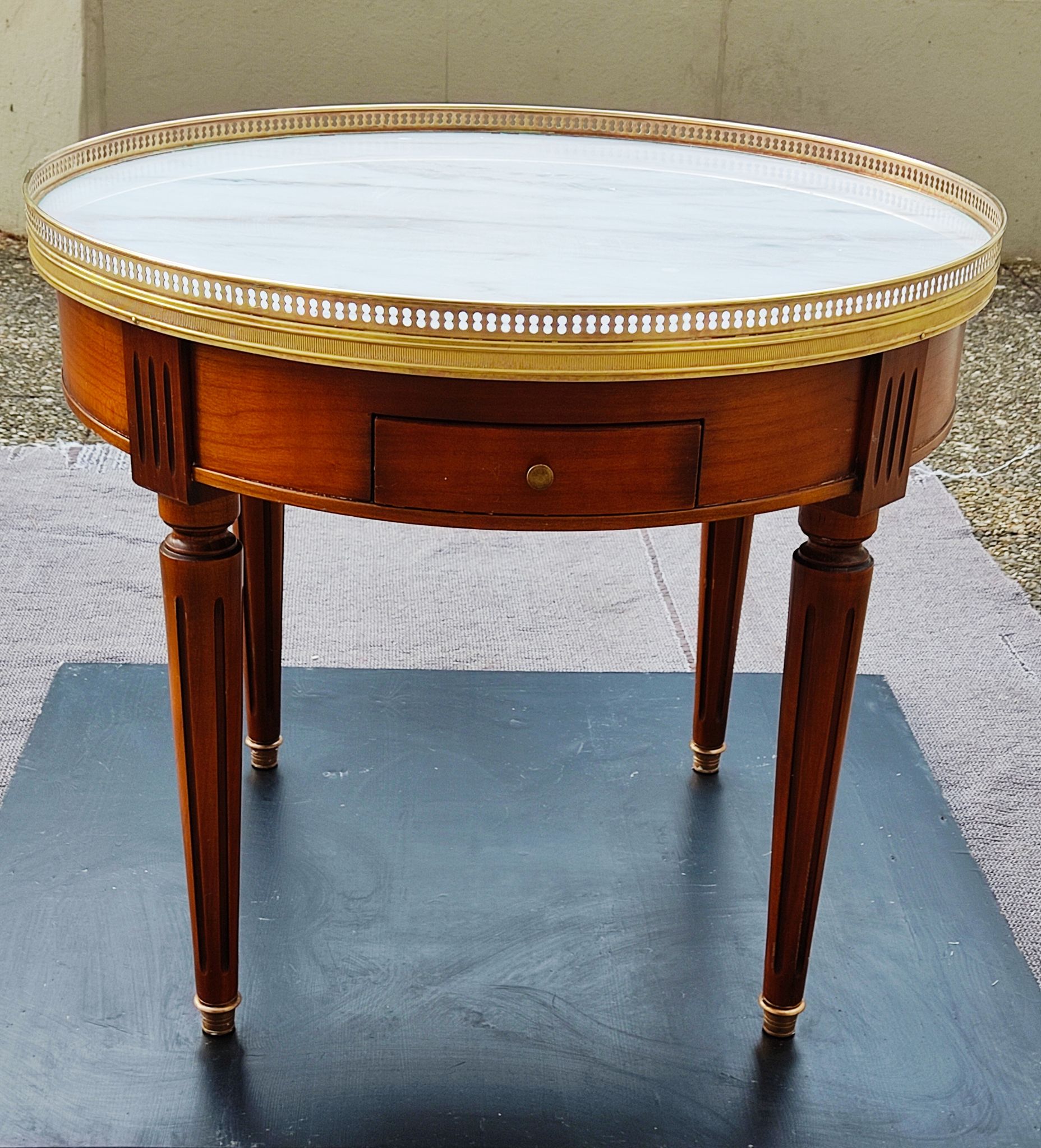 French hot water bottle table in Louis XVI style (1890); marble top and bronze gallery