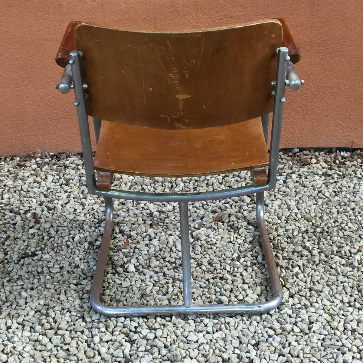 Modernist armchair in plywood, screwed steel tubes
