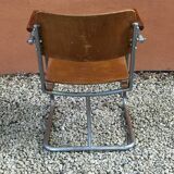 Modernist armchair in plywood, screwed steel tubes