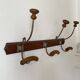 Old wooden and metal wall-mounted coat rack.