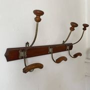 Old wooden and metal wall-mounted coat rack.