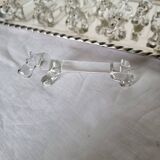 A charming set of 12 molded glass knives rests in the shape of a dog