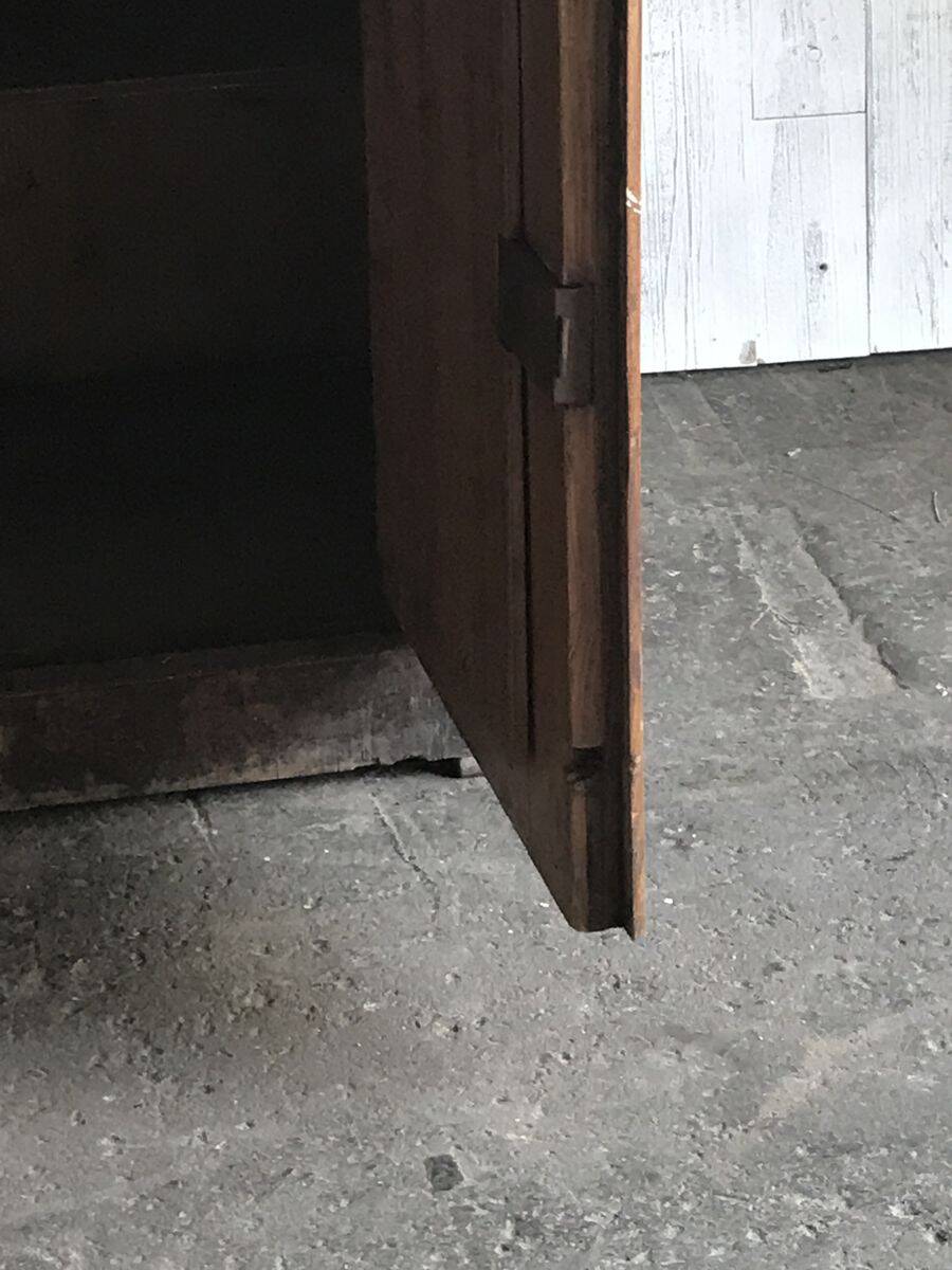 Vintage brown pine dresser with a painted top, moulded panels, and decorative locks.