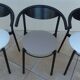 6 gondola-style chairs with a sturdy metal frame and faux leather.
