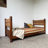 Brutalist style bed with chain and straw