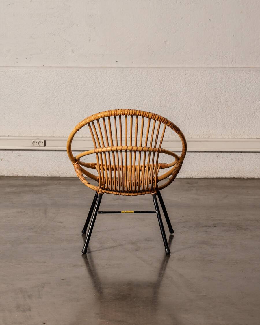 Rattan armchair with metal legs