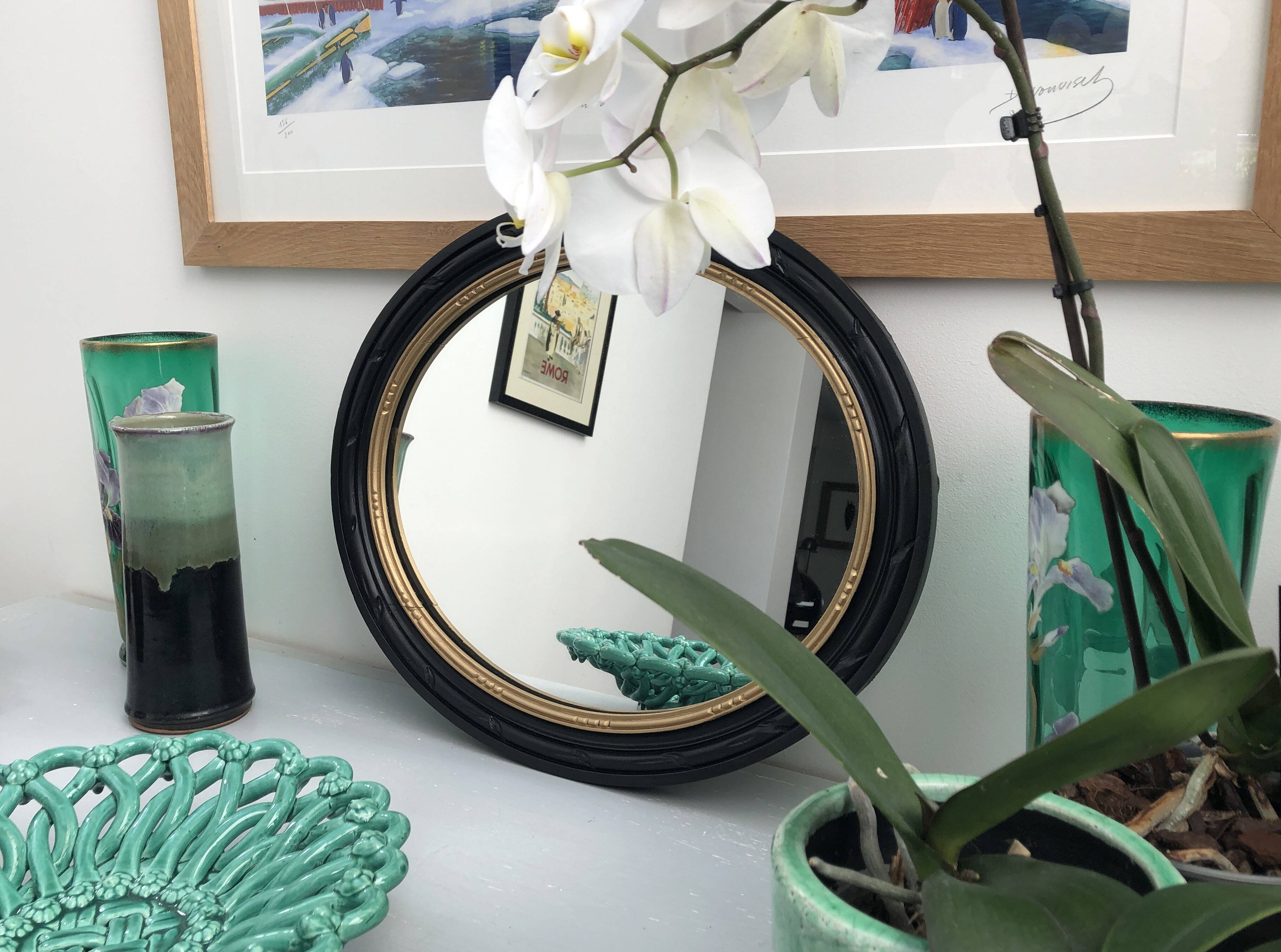 black and gold oval mirror
