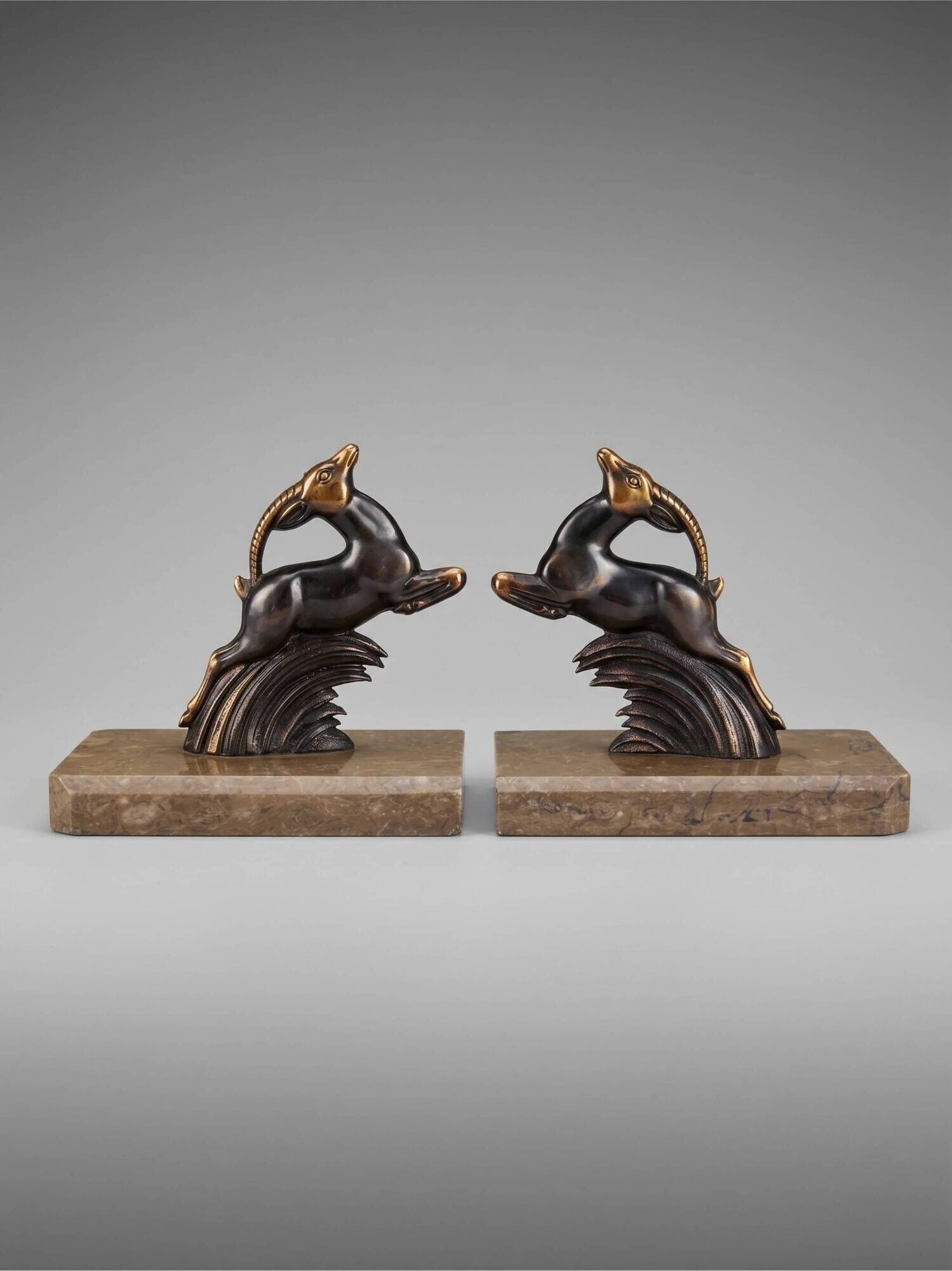 Art Deco bookends in patinated metal – animal pair – marble bases