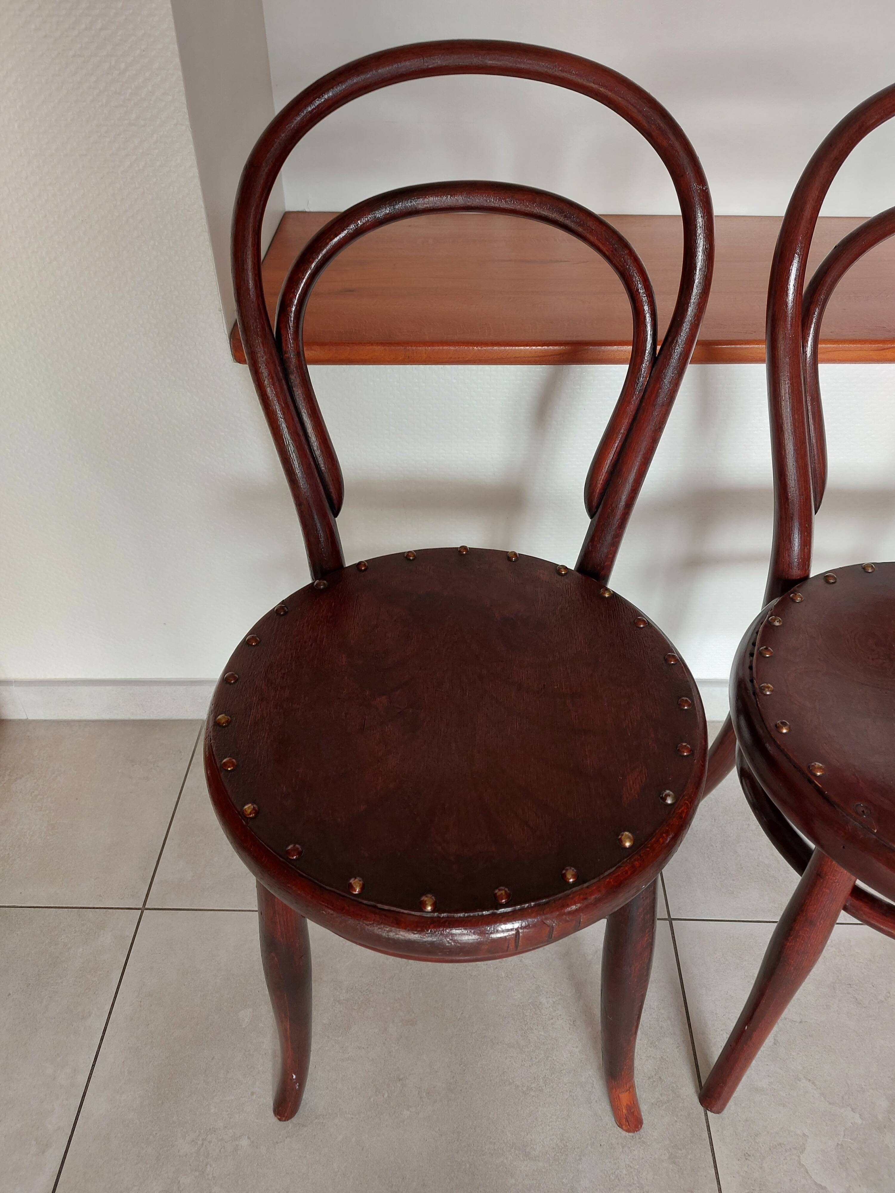 pair of round bistro chairs with a pattern on the seat, vintage