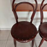 pair of round bistro chairs with a pattern on the seat, vintage