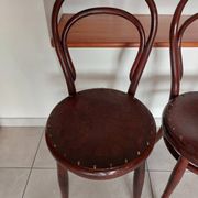 pair of round bistro chairs with a pattern on the seat, vintage