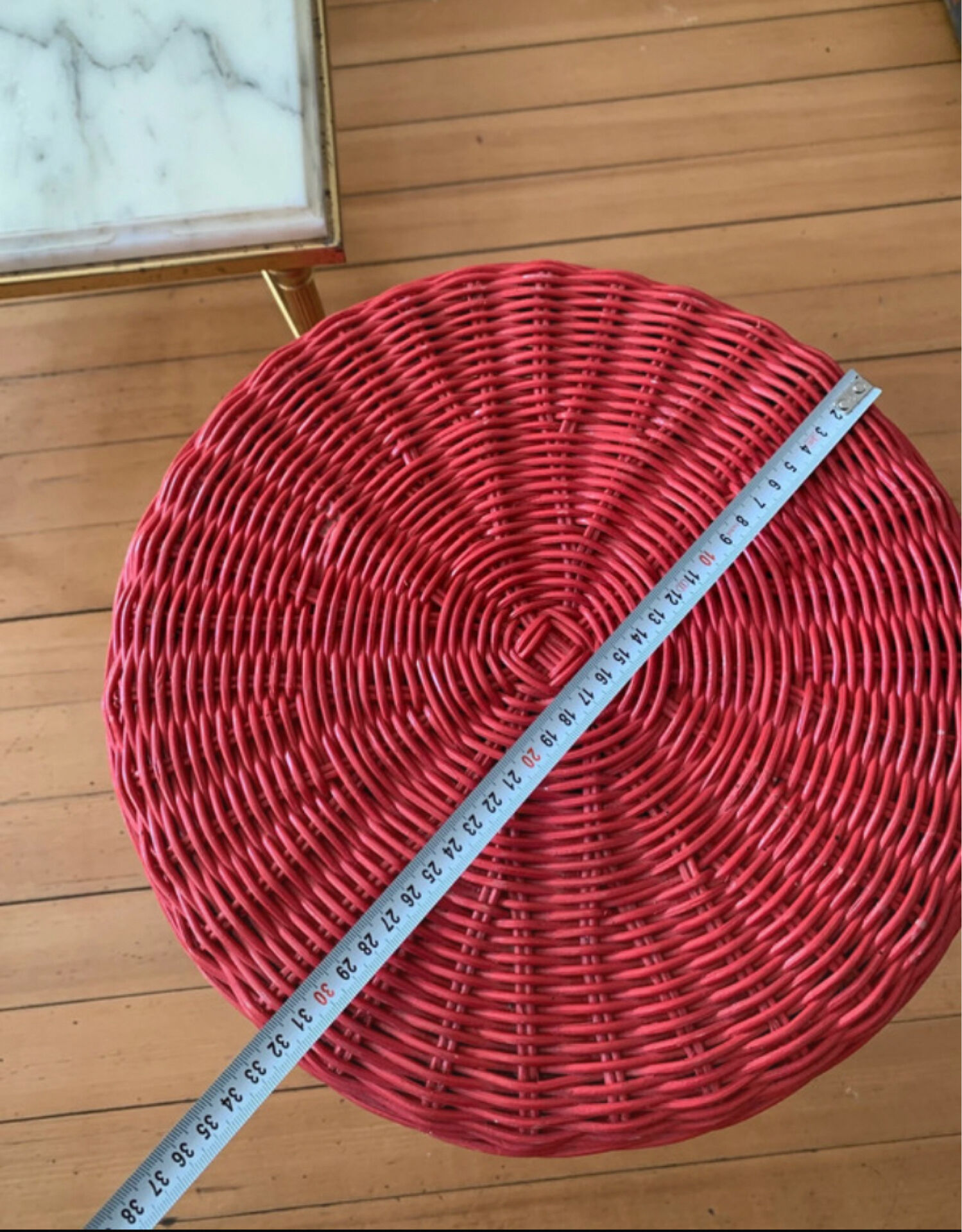 Vintage hourglass stool in red wicker or woven rattan.
