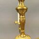 Older brass alloy chandelier with three light sources.