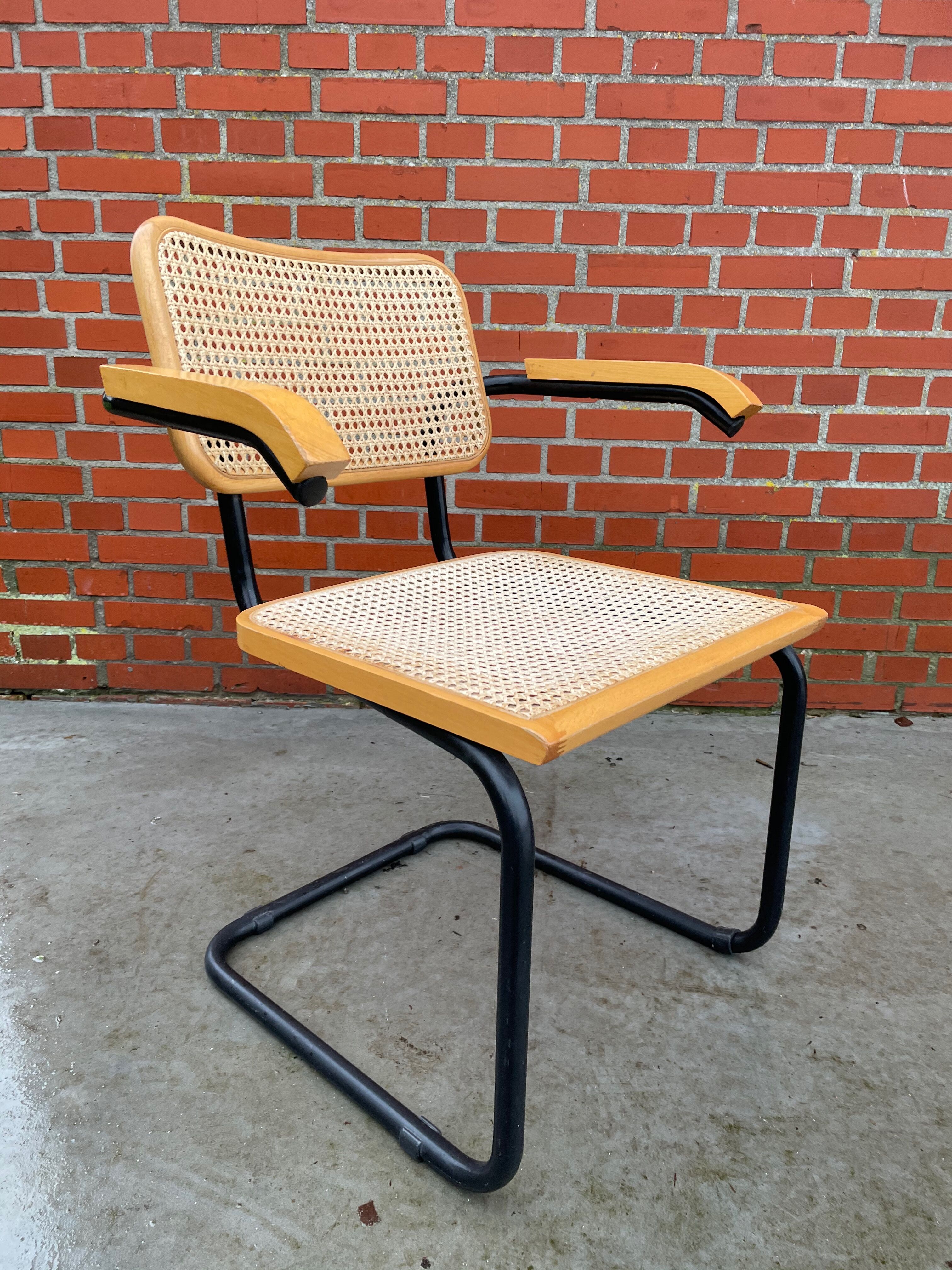Cesca model chair designed by Marcel Breuer with black-framed armrests