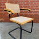 Cesca model chair designed by Marcel Breuer with black-framed armrests