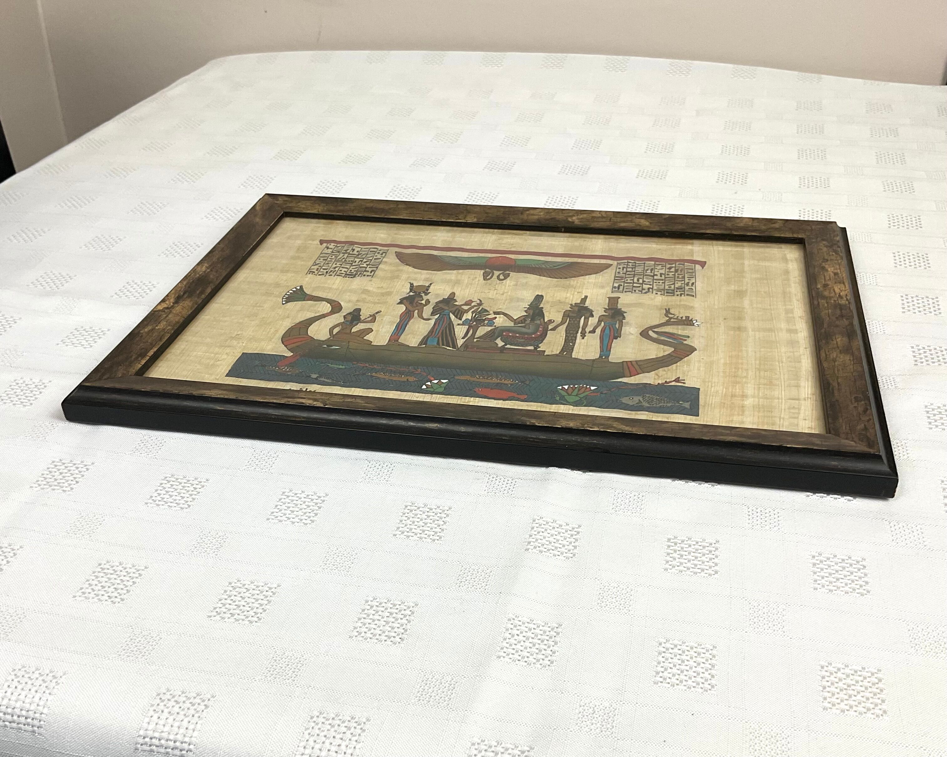 Egyptian papyrus under glass in wooden frame