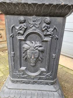 Large antique cast iron vases on pedestal