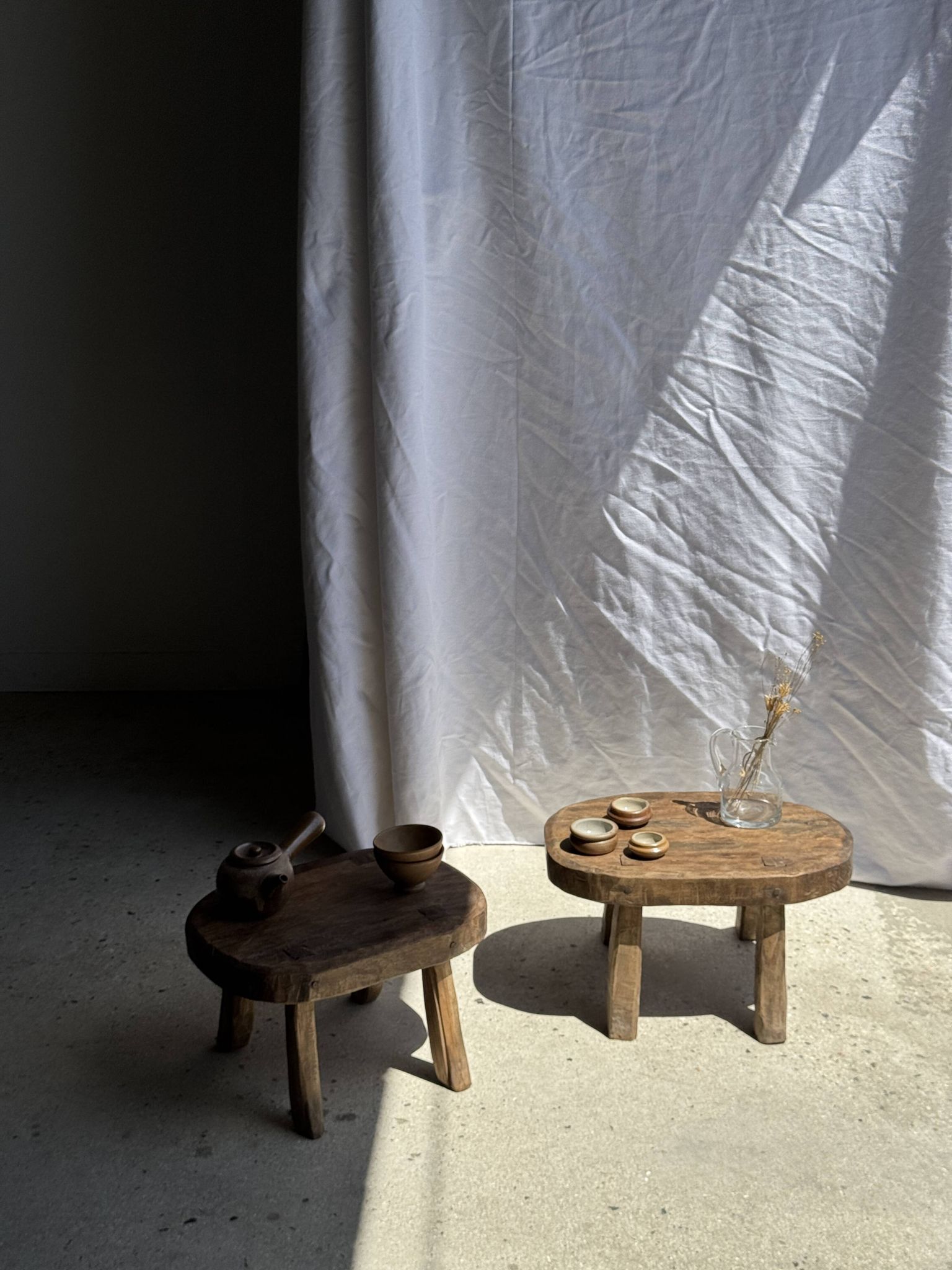 Small stool, oval solid teak side table with curved legs in wabi-sabi style.