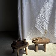 Small stool, oval solid teak side table with curved legs in wabi-sabi style.