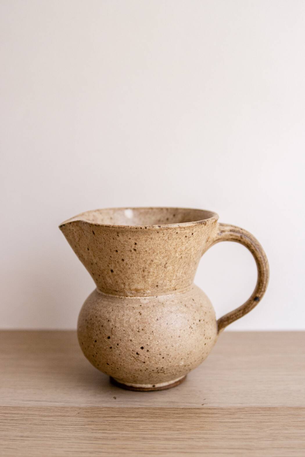 Small pitcher in old speckled stoneware