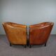 Set de 2 fauteuils Art Déco en cuir de mouton passepoil noir