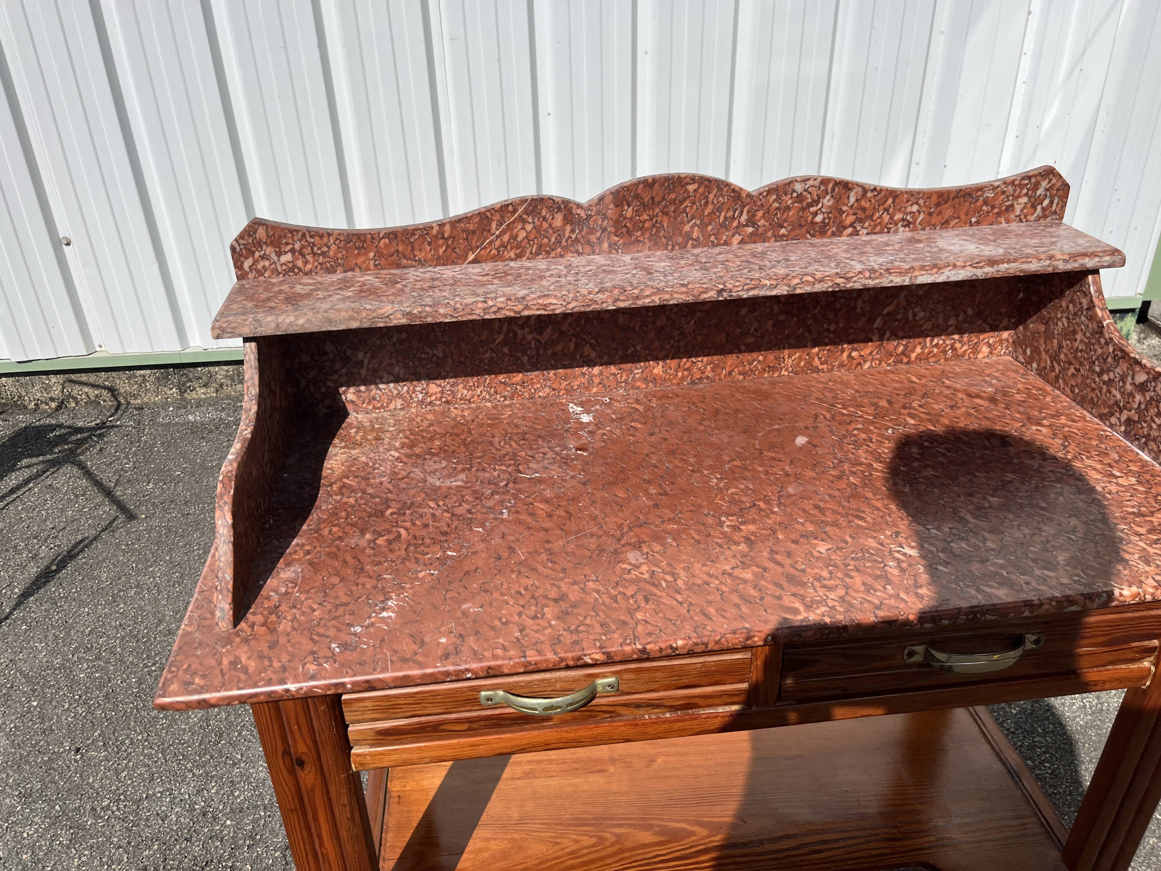 Antique wooden and red marble bathroom cabinet