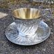 Cup and saucer in solid silver.