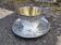 Cup and saucer in solid silver.