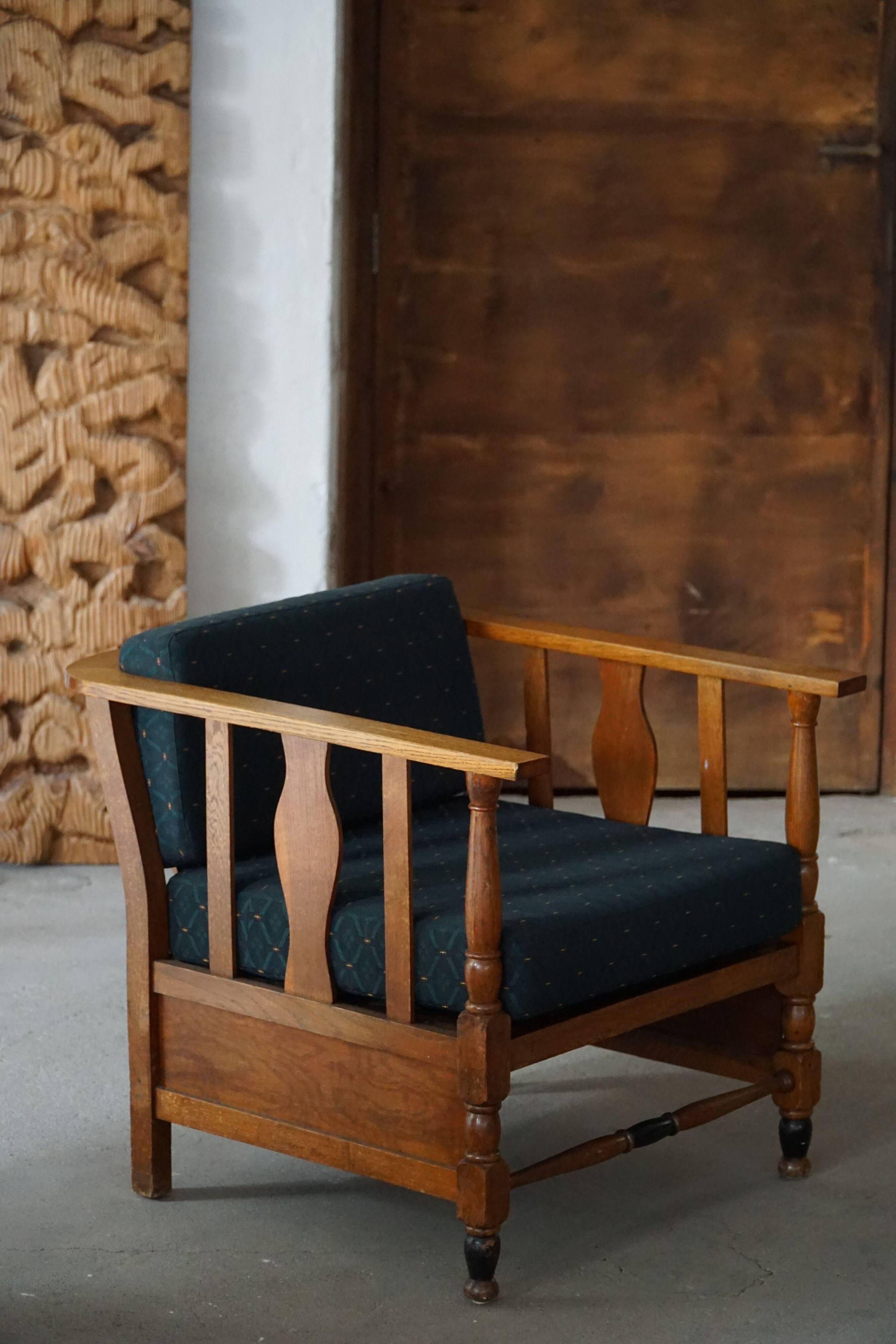 Art Nouveau, pair of oak lounge chairs, reupholstered in style fabric, 1920s.