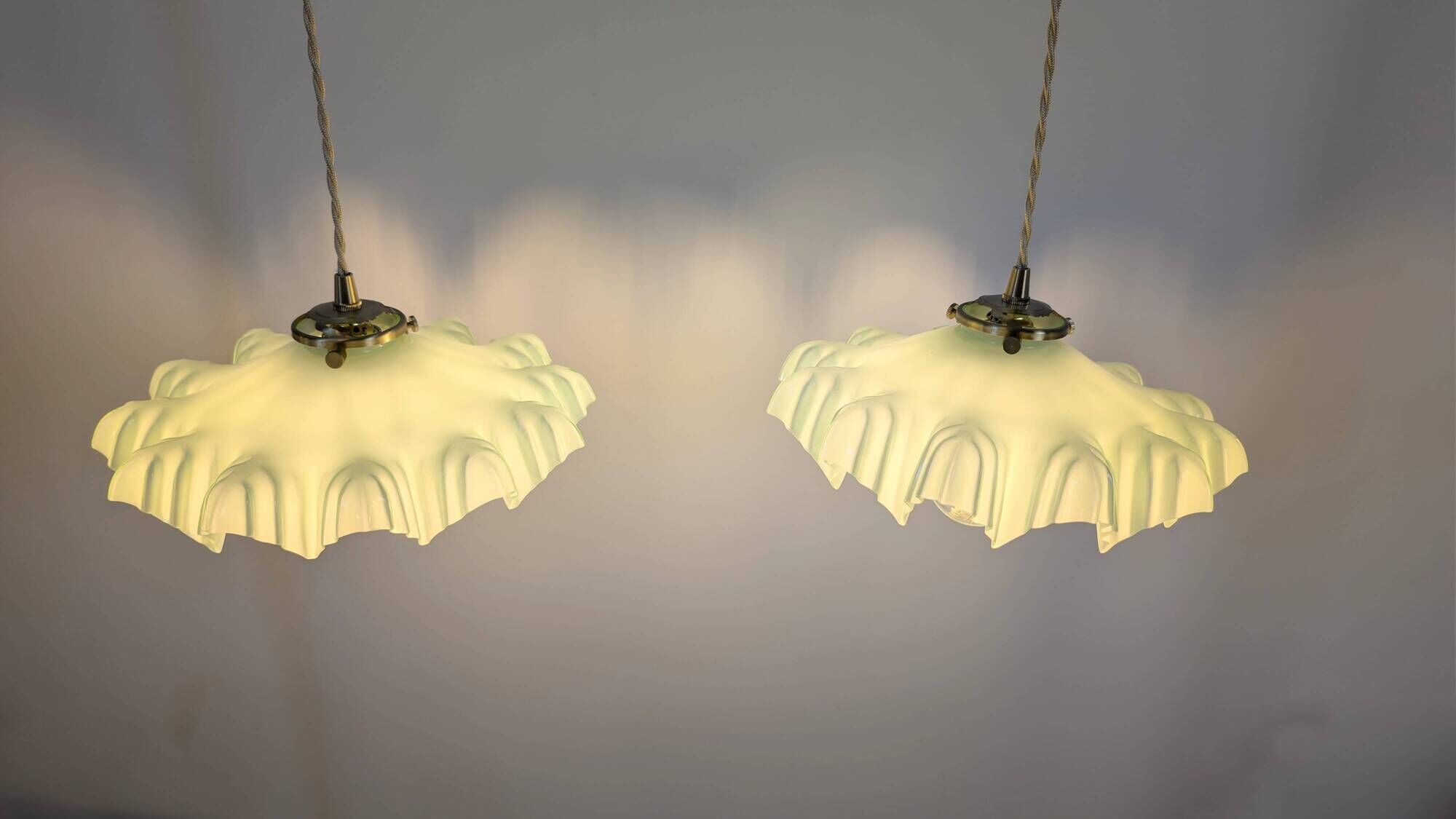 Pair of green opaline glass pendant lights – frosted poetry & Art Deco brilliance