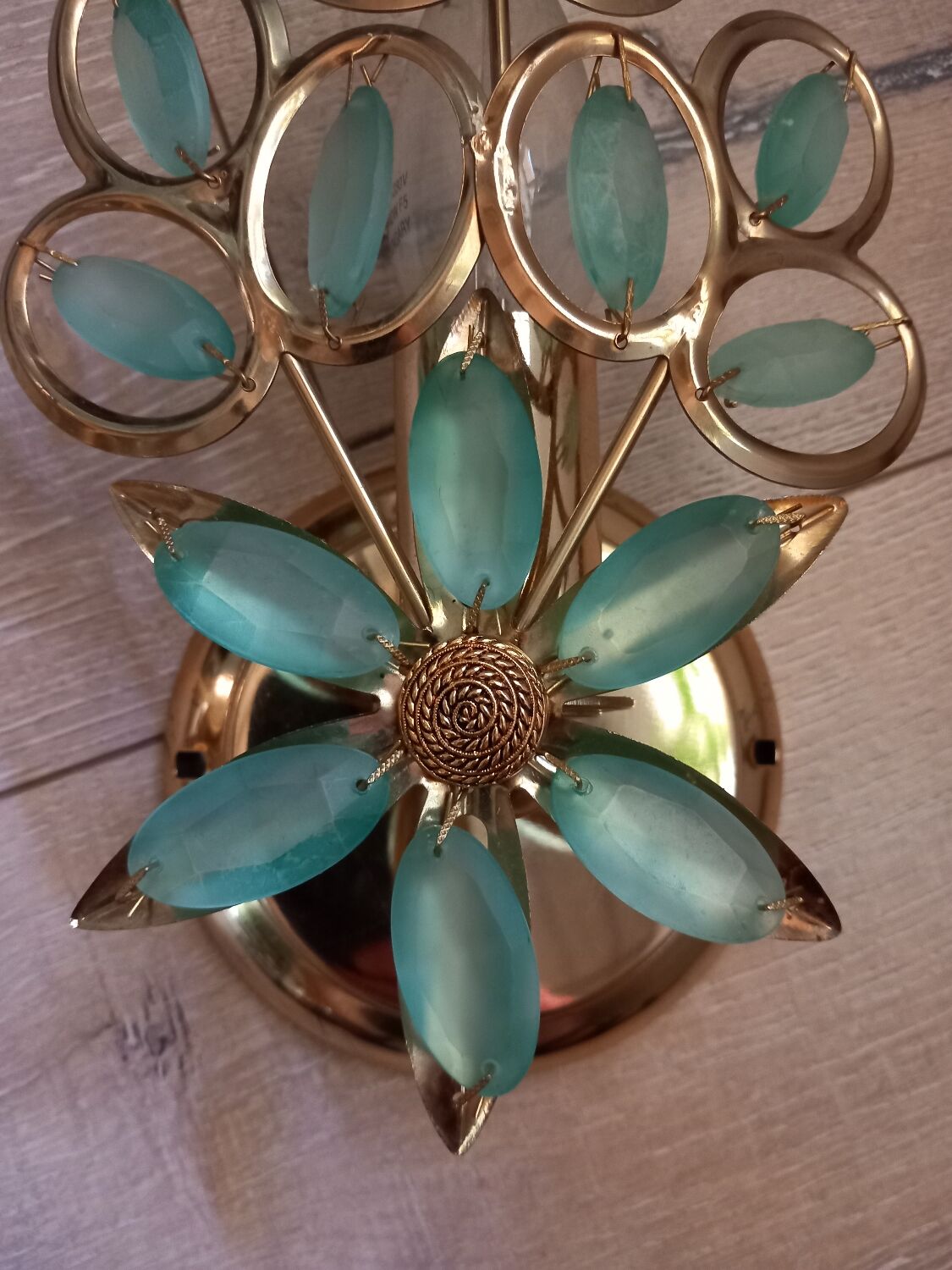 Gold metal wall light with light blue tassels