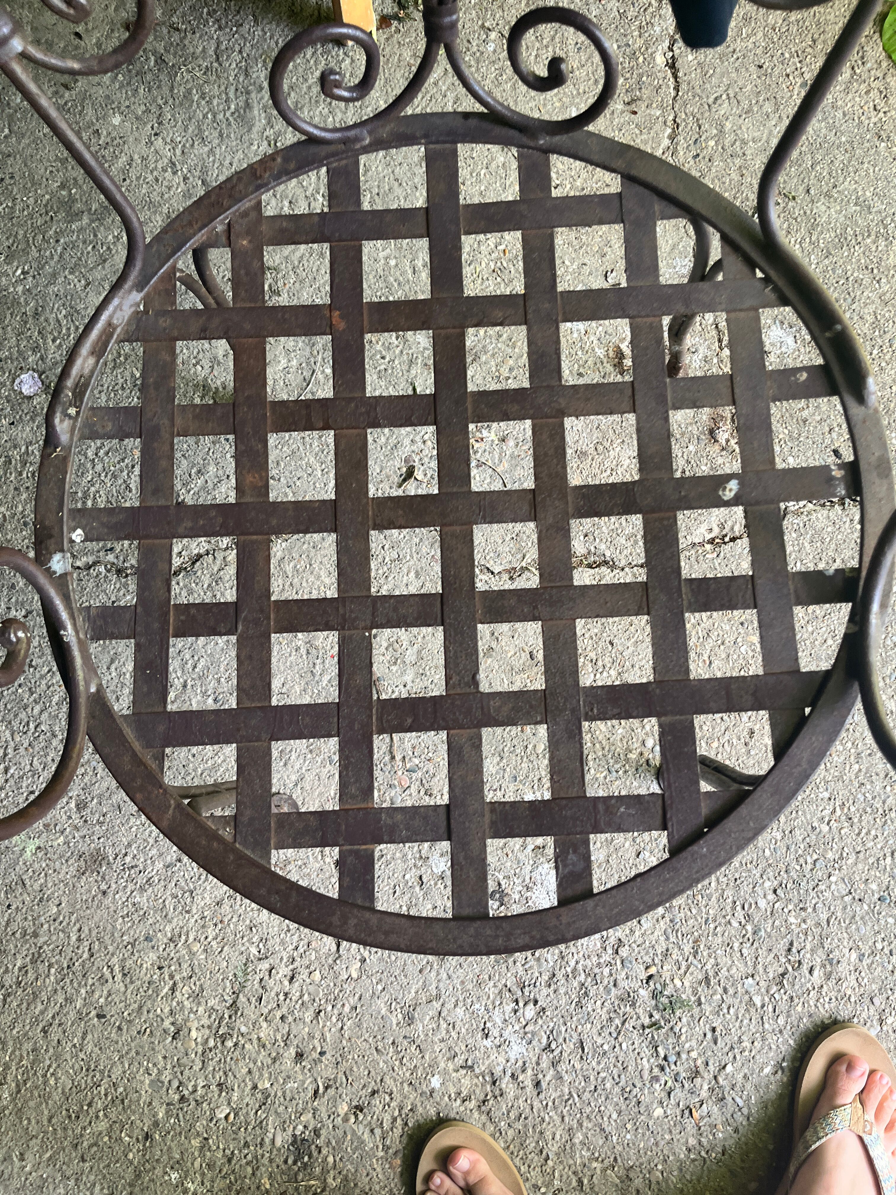 Old wrought iron table and its armchairs and chairs for outdoor use.