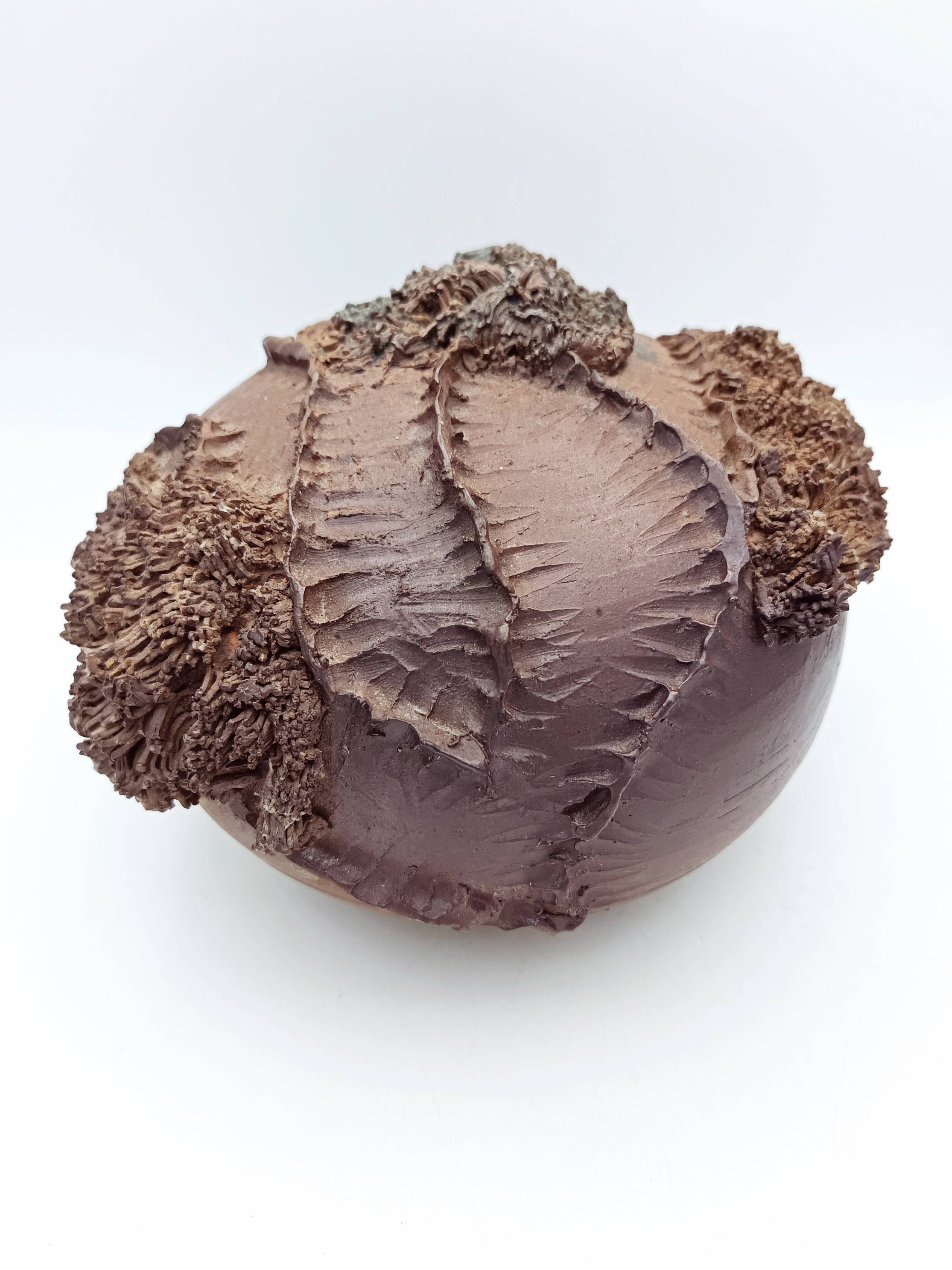 Ceramic vase with organic plant decoration