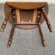 Round kitchen or dining table with extendable leaves in dark wood.