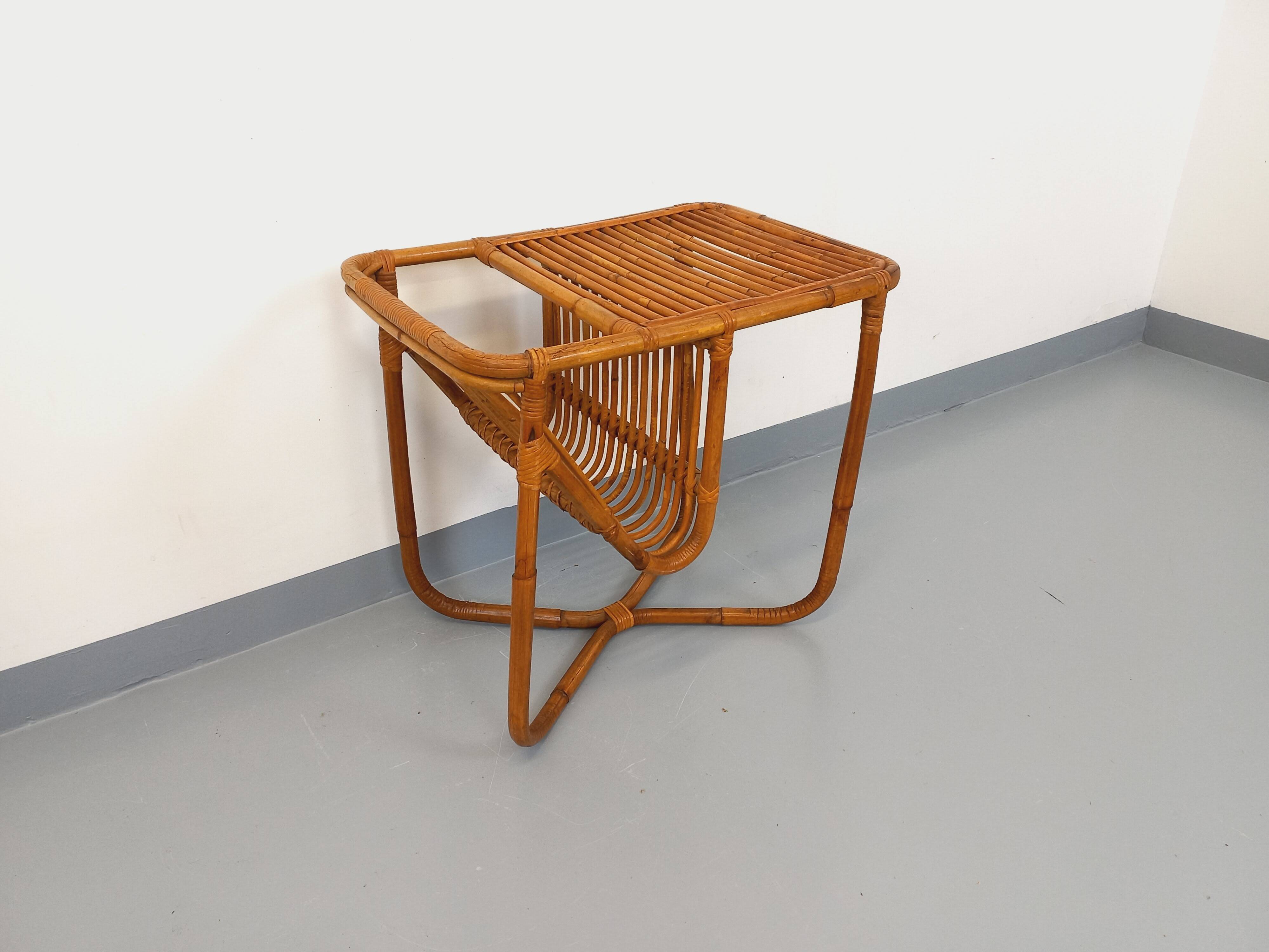 Side table / coffee table with vintage 1960s rattan magazine rack.