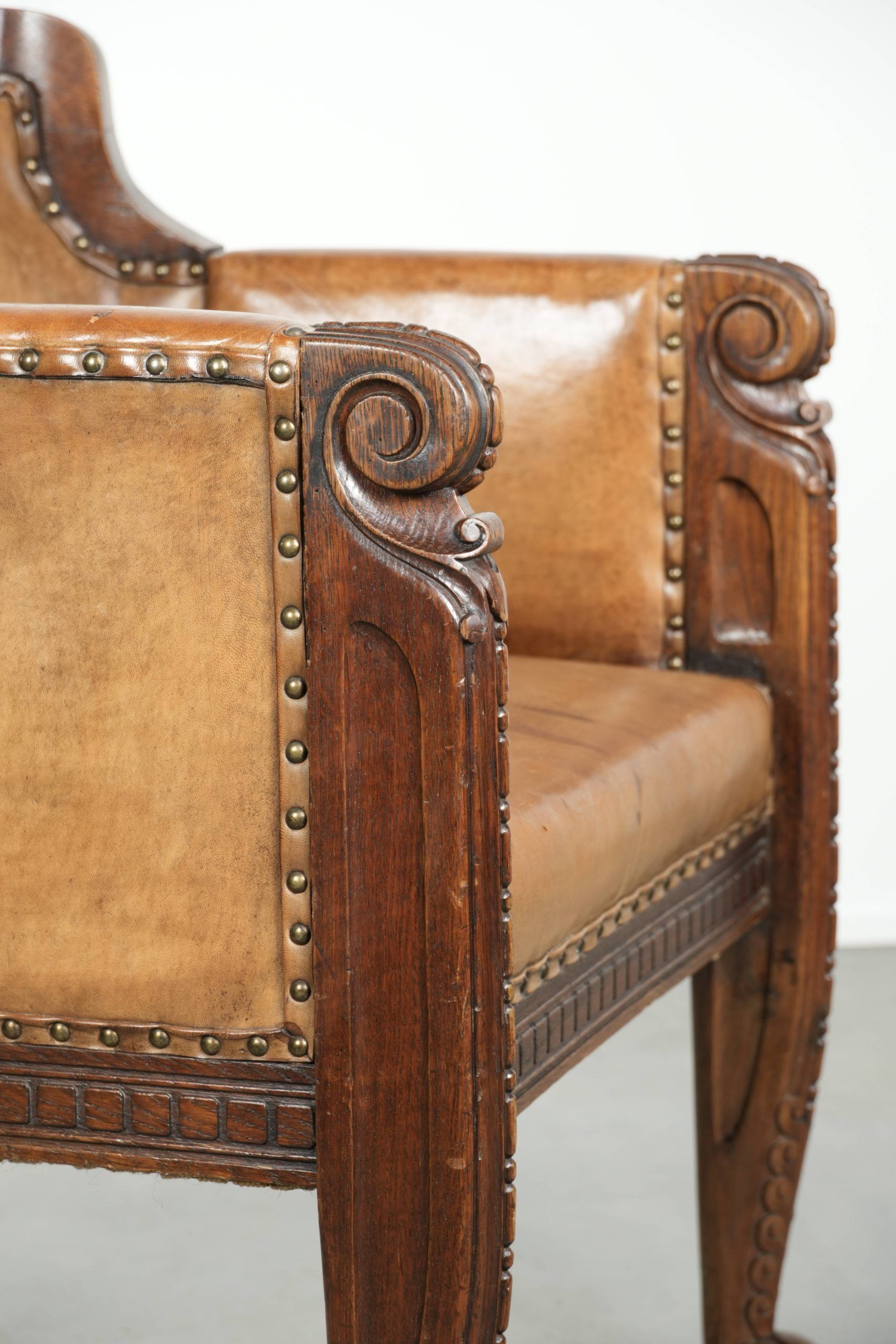 Antique armchair made of sheepskin and wood with decorative nails