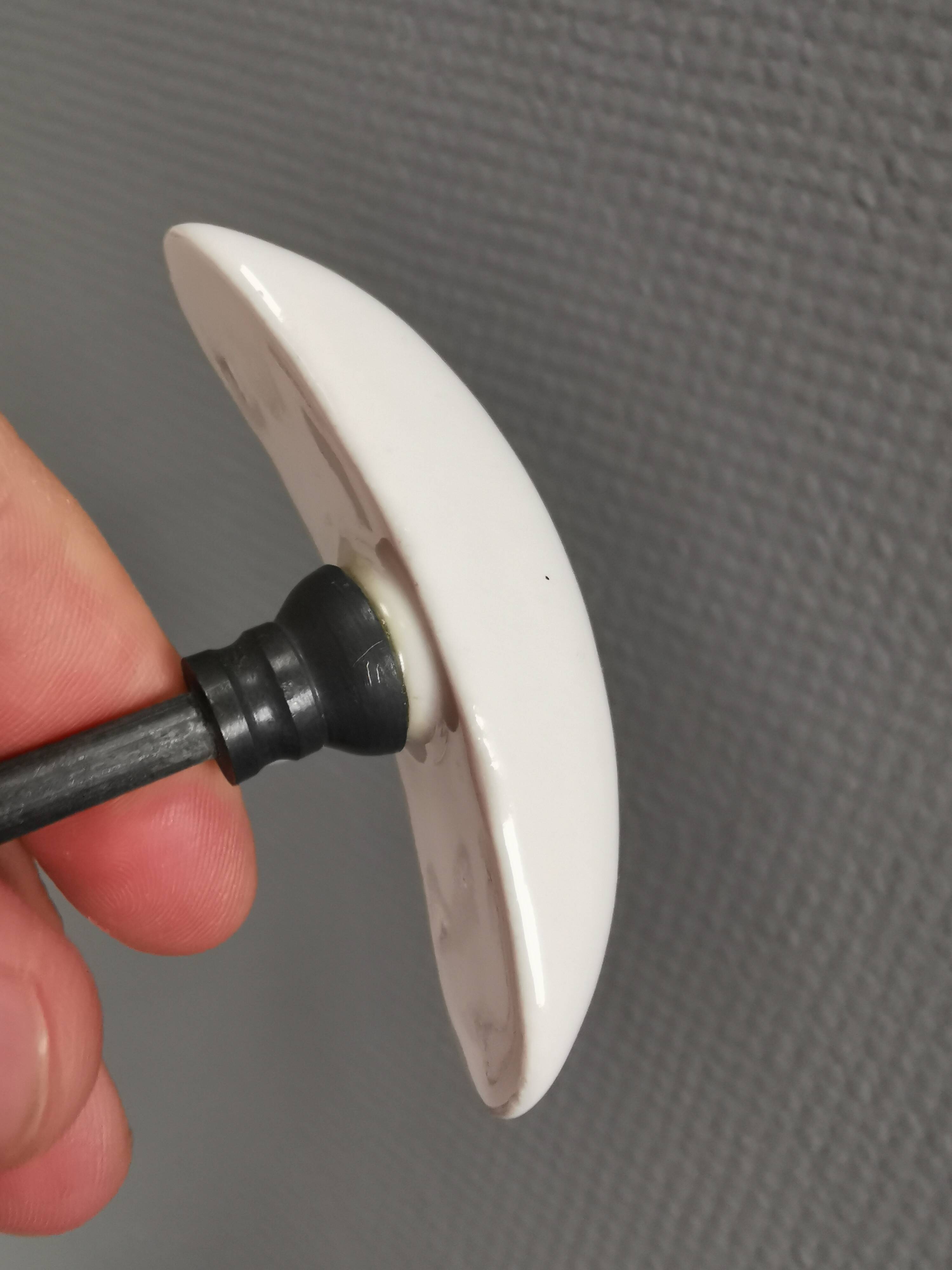 Coat hooks made of galvanized brass and raw white porcelain