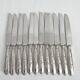 12 antique silver-plated knives with acanthus shell decoration and stainless steel blades.
