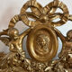 Large antique baroque mirror with angel decorations.