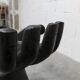 Black armchair chair in carved wood in the shape of a hand